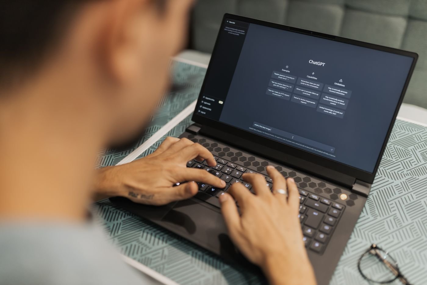 A man reviewing an AI chat assistant interface on his laptop
