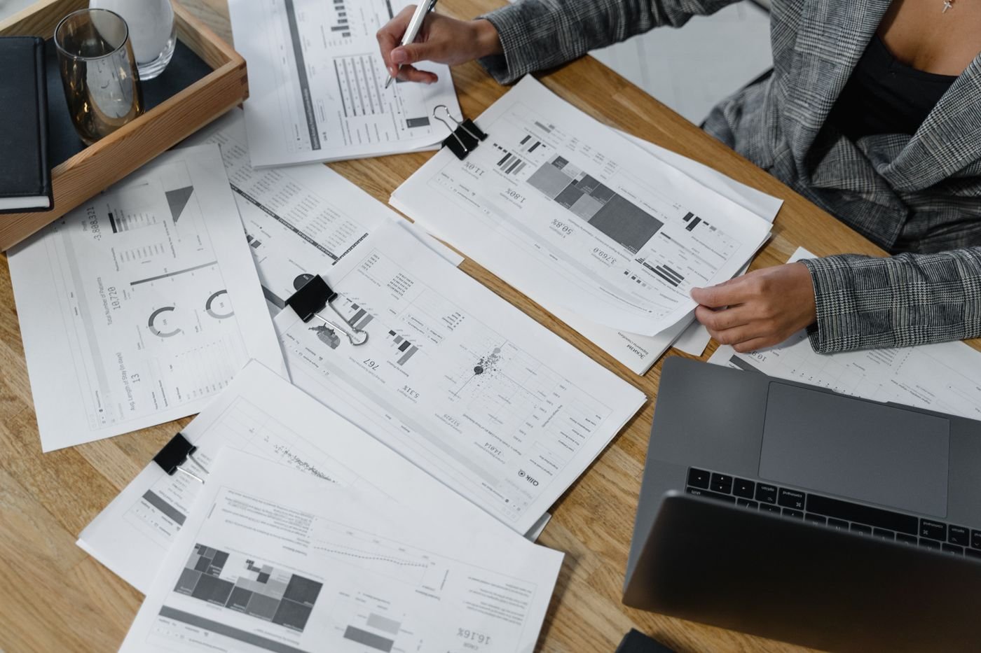 Reviewing reports and documents spread across a desk