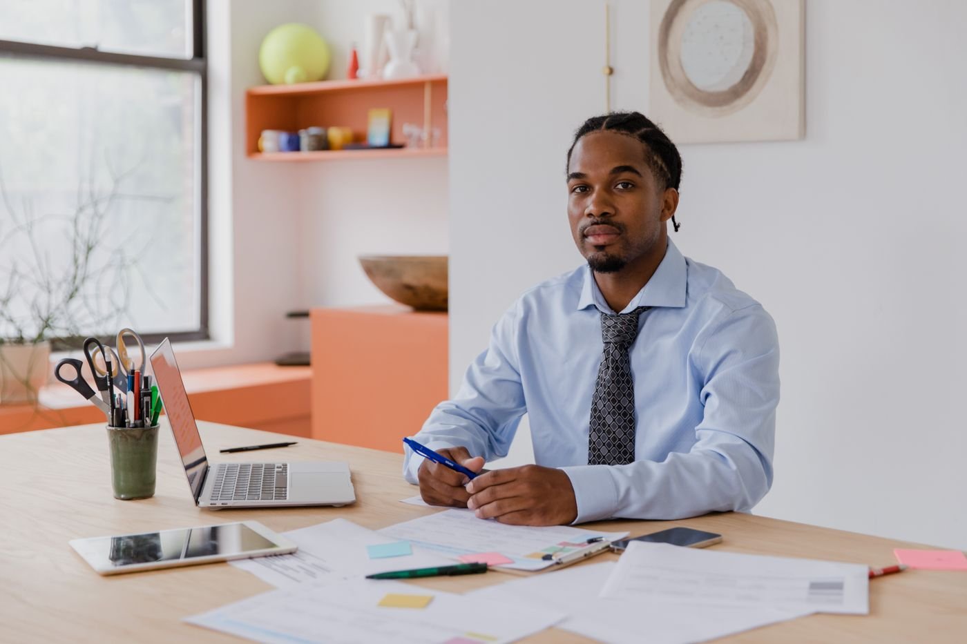 A professional working at his desk, ready to respond to enquiries