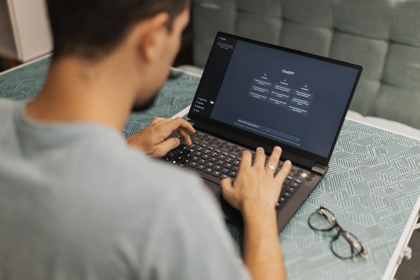 A man using an AI chat assistant on his laptop at work