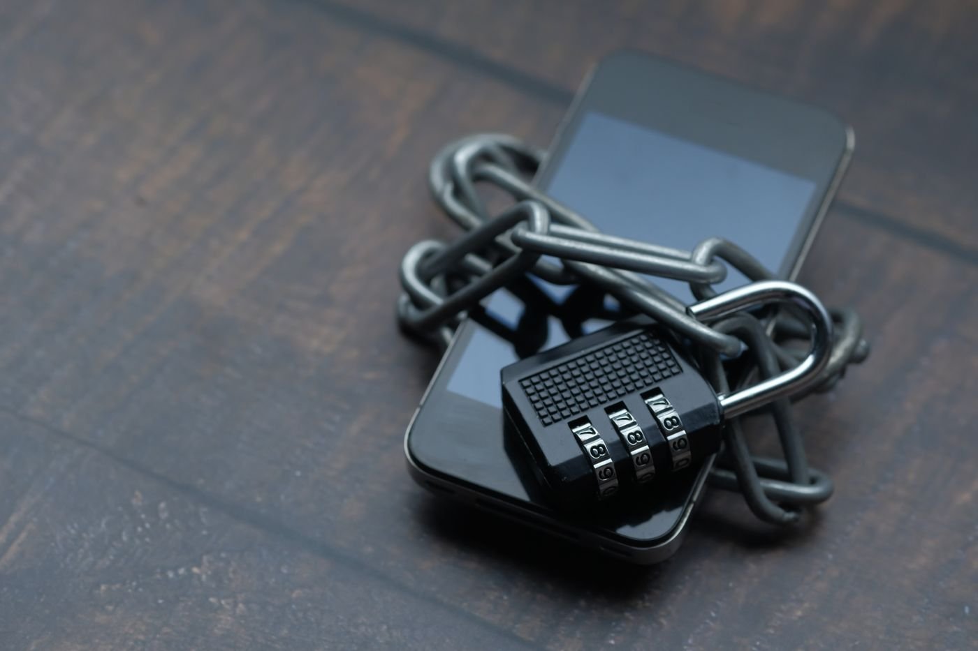 Close up of a smartphone showing a lock icon, representing device security
