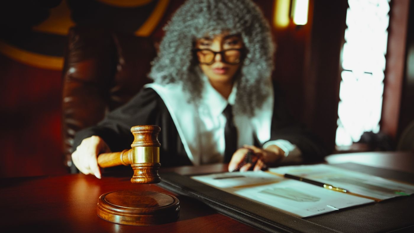 A courtroom desk with a gavel and legal documents, representing regulatory compliance
