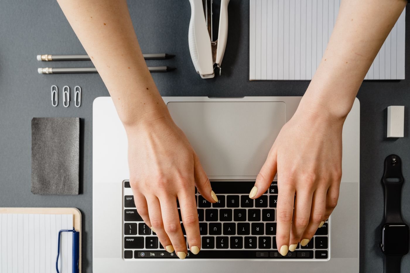 A person typing on a laptop at a desk, representing everyday IT-supported work