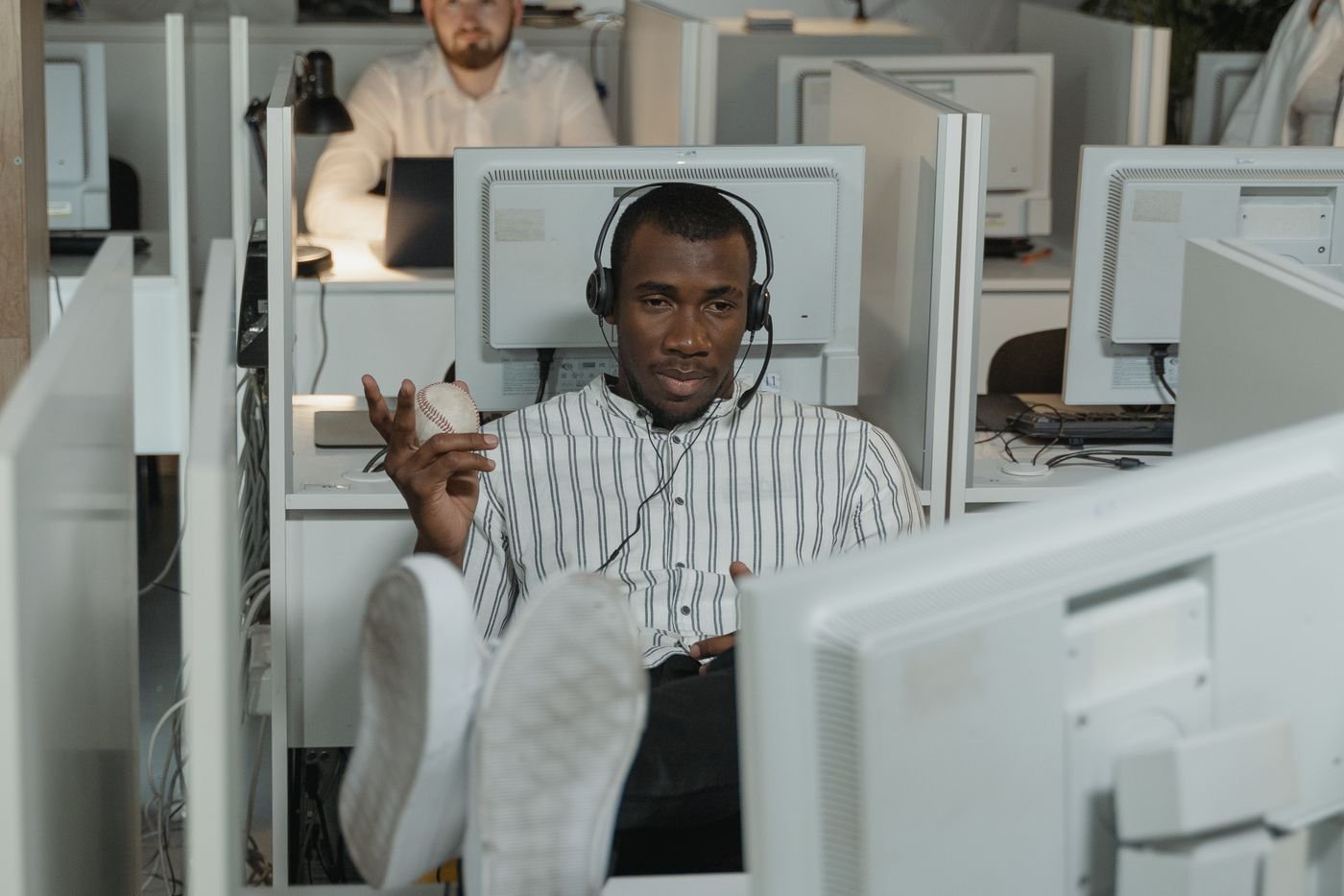 Person wearing a headset taking a business call in the office